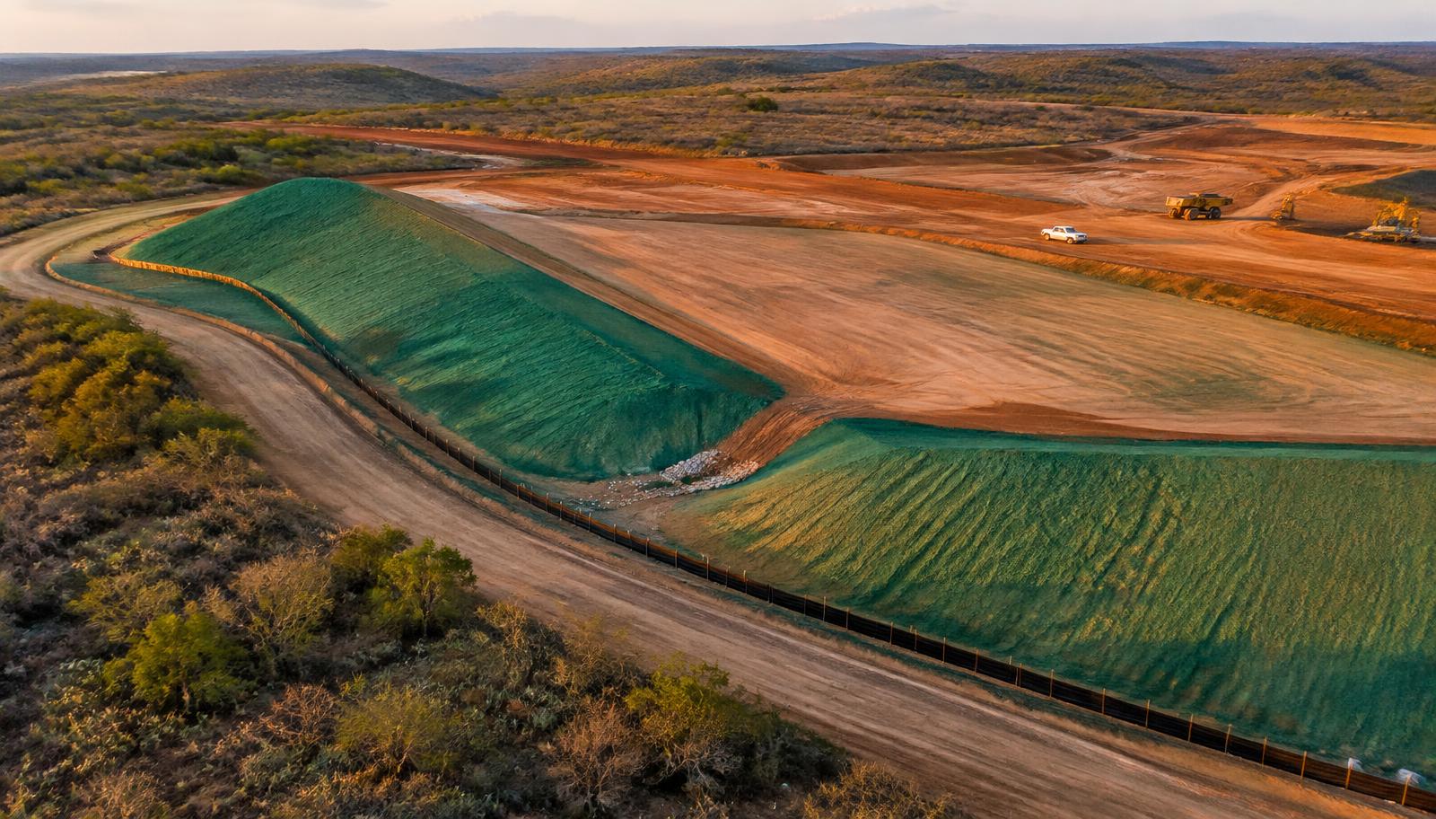 Aerial view of a South Texas construction site with silt fencing and hydroseeded slopes